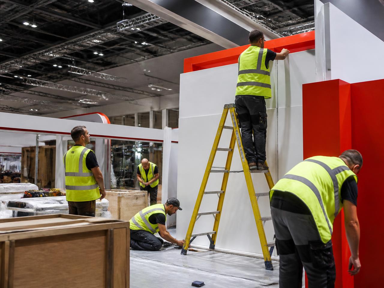 Crew building an exhibition stand on site